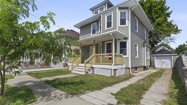 33 Marion Ave, Providence, RI 02905 - traditional style home featuring concrete driveway, a porch, a detached garage, and an outbuilding