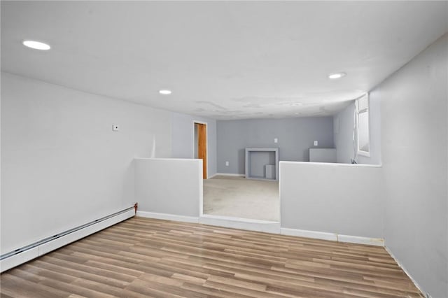 18 Ortoleva Dr, Providence, RI 02909 - empty room featuring a baseboard radiator, recessed lighting, and wood finished floors