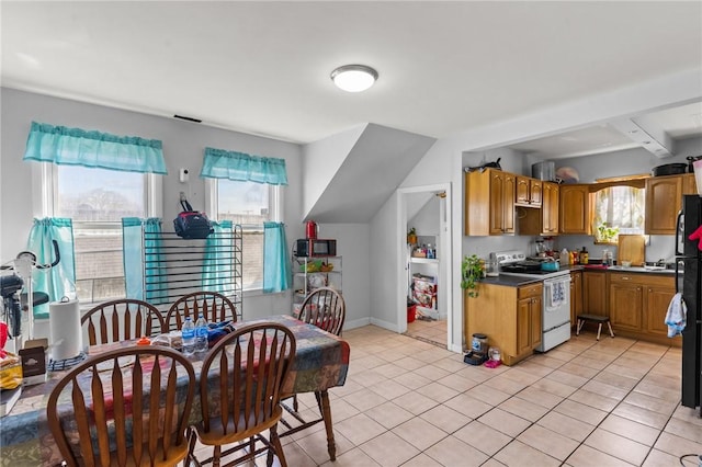 18 Ortoleva Dr, Providence, RI 02909 - kitchen with stove, healthy amount of natural light, light tile patterned floors, and dark countertops