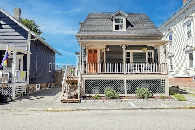 6 Pond Ave, Newport, RI 02840 - victorian home featuring covered porch, roof with shingles, and stairway