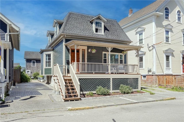 6 Pond Ave, Newport, RI 02840 - second empire-style home with a porch, a shingled roof, driveway, and mansard roof