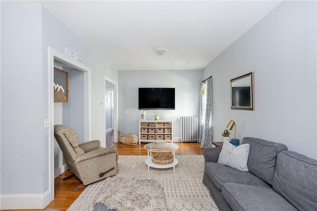 6 Pond Ave, Newport, RI 02840 - living area with radiator and light wood-style flooring