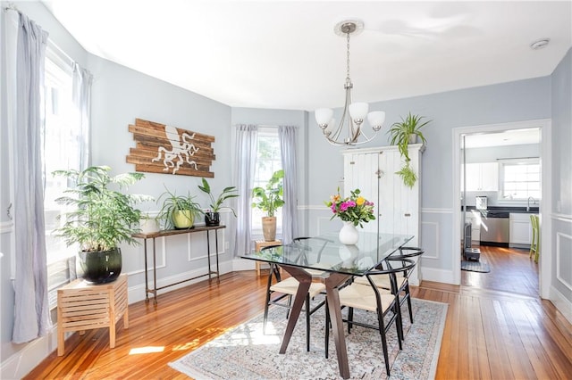 6 Pond Ave, Newport, RI 02840 - dining area with a chandelier, healthy amount of natural light, and light wood-style flooring