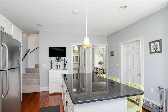6 Pond Ave, Newport, RI 02840 - kitchen featuring freestanding refrigerator, dark wood finished floors, white cabinets, radiator heating unit, and dark stone counters