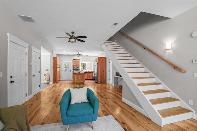 888 Plainfield Pike, Coventry, RI 02827 - living room featuring stairway, a ceiling fan, and light wood-style floors