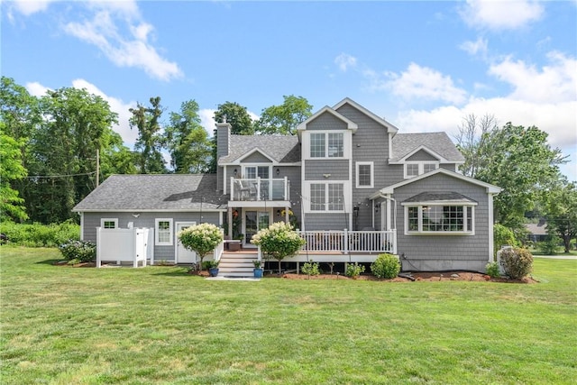 12 Windward Cir, Warwick, RI 02889 - back of house featuring a chimney, a deck, a yard, a balcony, and a shingled roof