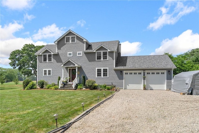 12 Windward Cir, Warwick, RI 02889 - view of front of property with driveway, a garage, a front lawn, and roof with shingles