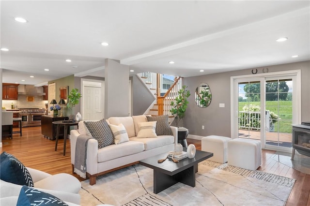 12 Windward Cir, Warwick, RI 02889 - living room featuring light wood-type flooring, stairway, plenty of natural light, recessed lighting, and a wood stove