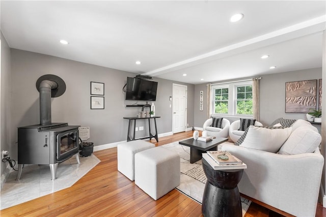 12 Windward Cir, Warwick, RI 02889 - living area with light wood-type flooring, recessed lighting, and a wood stove