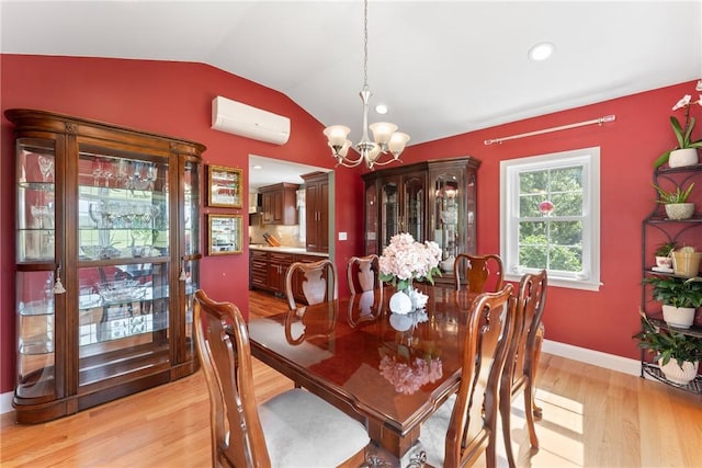 12 Windward Cir, Warwick, RI 02889 - dining area with an AC wall unit, a chandelier, vaulted ceiling, light wood-style floors, and recessed lighting