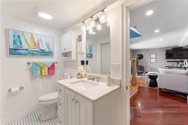 12 Windward Cir, Warwick, RI 02889 - bathroom with a wood stove, vanity, recessed lighting, and wood finished floors