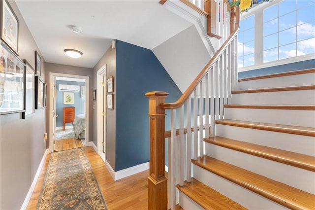 12 Windward Cir, Warwick, RI 02889 - stairway with a wall mounted air conditioner, wood finished floors, and healthy amount of natural light