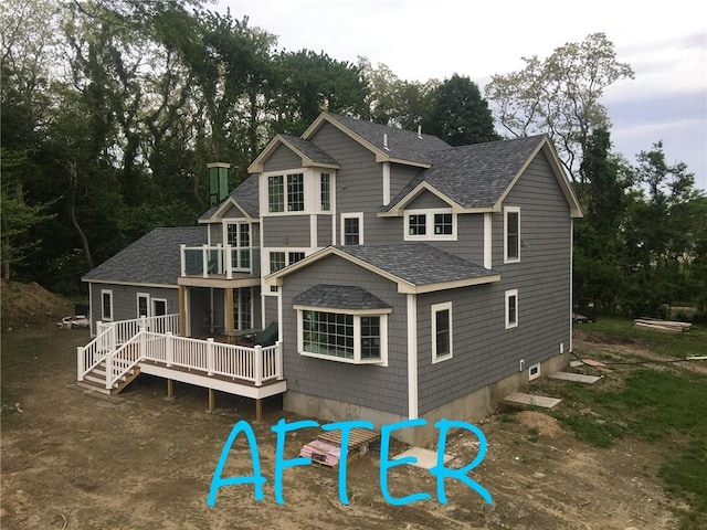 12 Windward Cir, Warwick, RI 02889 - back of property featuring roof with shingles, a deck, a balcony, and view of scattered trees