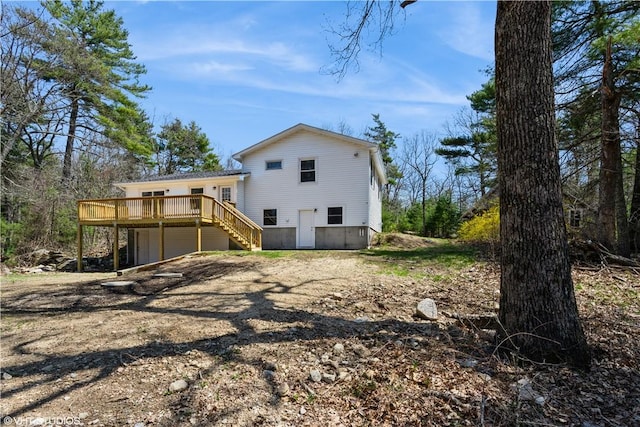 22 T Parker Rd, Foster, RI 02825 - rear view of property with a wooden deck, stairway, dirt driveway, and an attached garage