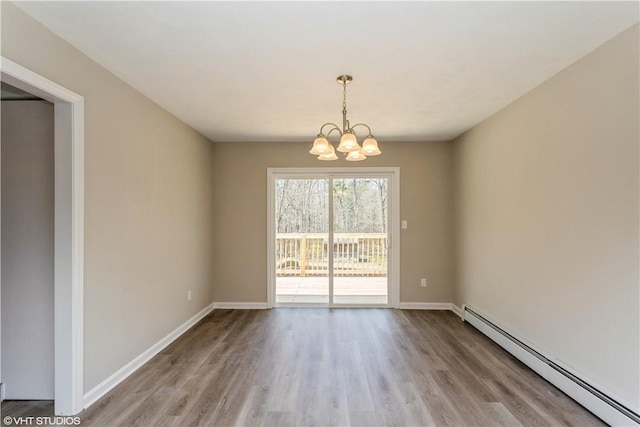 22 T Parker Rd, Foster, RI 02825 - spare room with a baseboard radiator, wood finished floors, and a chandelier