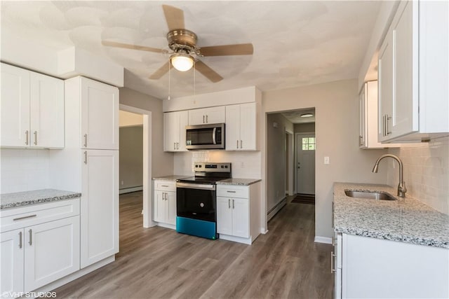 22 T Parker Rd, Foster, RI 02825 - kitchen featuring appliances with stainless steel finishes, decorative backsplash, a baseboard heating unit, and white cabinetry