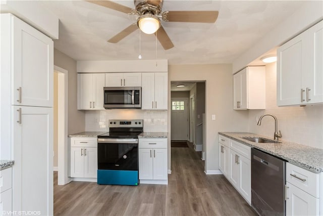 22 T Parker Rd, Foster, RI 02825 - kitchen featuring stainless steel appliances, decorative backsplash, a ceiling fan, and light wood-type flooring