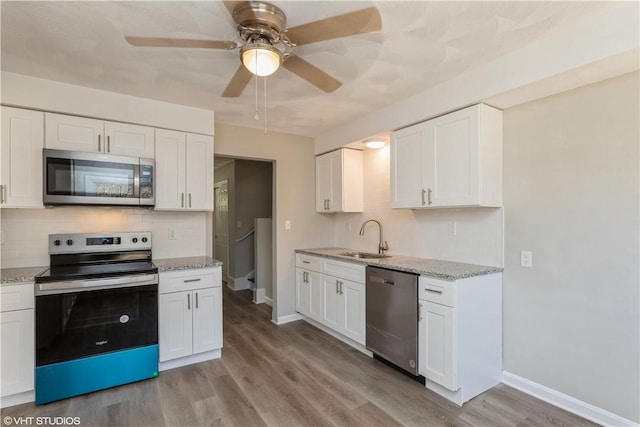 22 T Parker Rd, Foster, RI 02825 - kitchen with appliances with stainless steel finishes, backsplash, ceiling fan, and white cabinetry