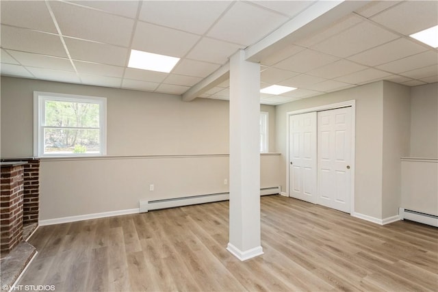 22 T Parker Rd, Foster, RI 02825 - below grade area featuring a drop ceiling, wood finished floors, baseboard heating, and a baseboard heating unit
