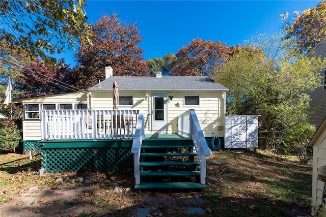 223 Mautucket Rd, South Kingstown, RI 02879 - back of house with a chimney and a wooden deck