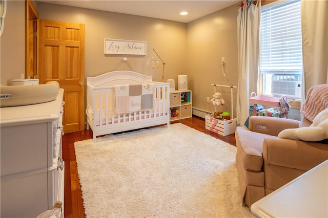 3642 Pawtucket Ave, East Providence, RI 02915 - bedroom with a crib, a baseboard radiator, wood finished floors, cooling unit, and recessed lighting