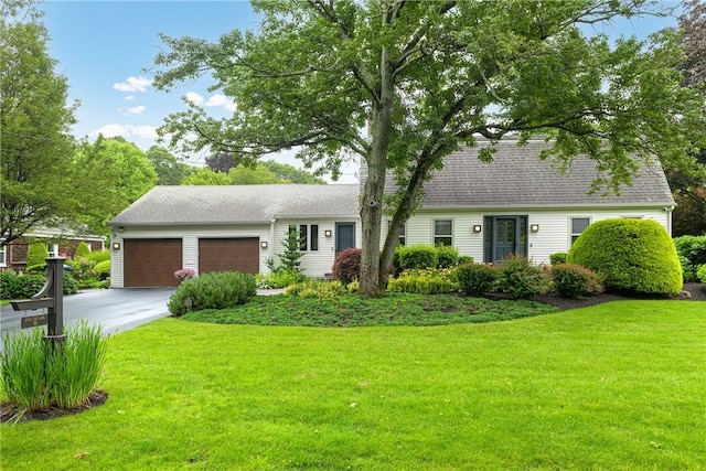 69 Apple Tree Ln, Warwick, RI 02888 - view of front facade with a garage, driveway, a front lawn, and roof with shingles