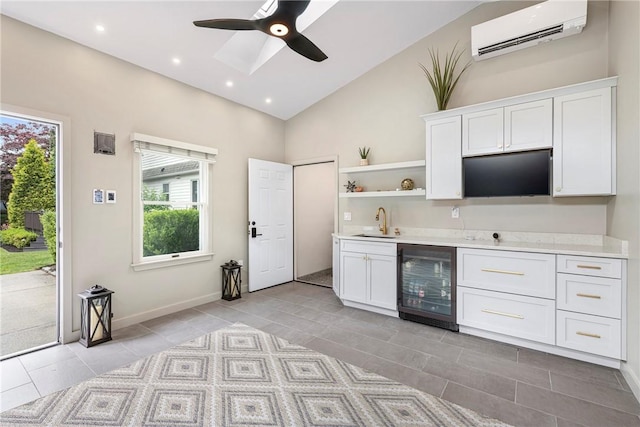 69 Apple Tree Ln, Warwick, RI 02888 - kitchen featuring wine cooler, a wall unit AC, light countertops, open shelves, and white cabinetry