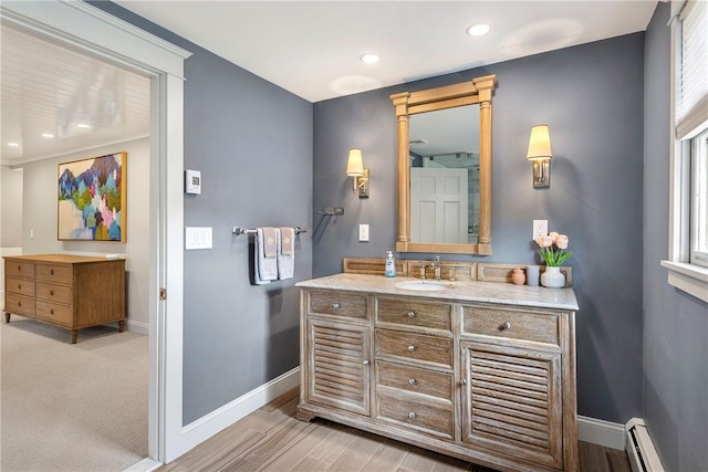 69 Apple Tree Ln, Warwick, RI 02888 - bathroom with a baseboard heating unit, vanity, recessed lighting, plenty of natural light, and wood finished floors