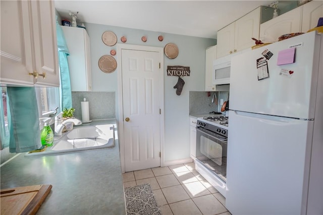 151 Willet Ave Unit 5, East Providence, RI 02915 - kitchen with white appliances, white cabinetry, decorative backsplash, light tile patterned floors, and light countertops