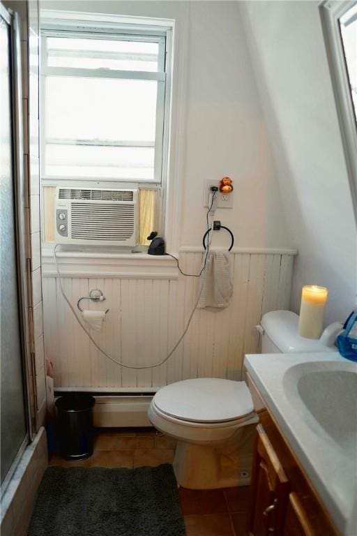23 Majestic Ave, Warwick, RI 02888 - bathroom featuring baseboard heating, tile patterned flooring, a shower stall, plenty of natural light, and a wainscoted wall
