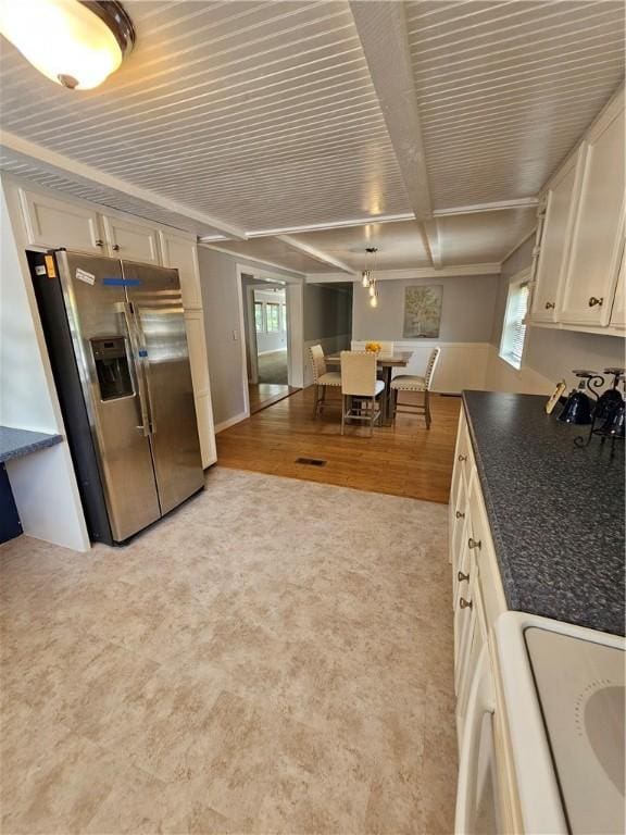 41 Park Ln, Coventry, RI 02816 - kitchen featuring stainless steel fridge, dark countertops, light colored carpet, white cabinetry, and stove
