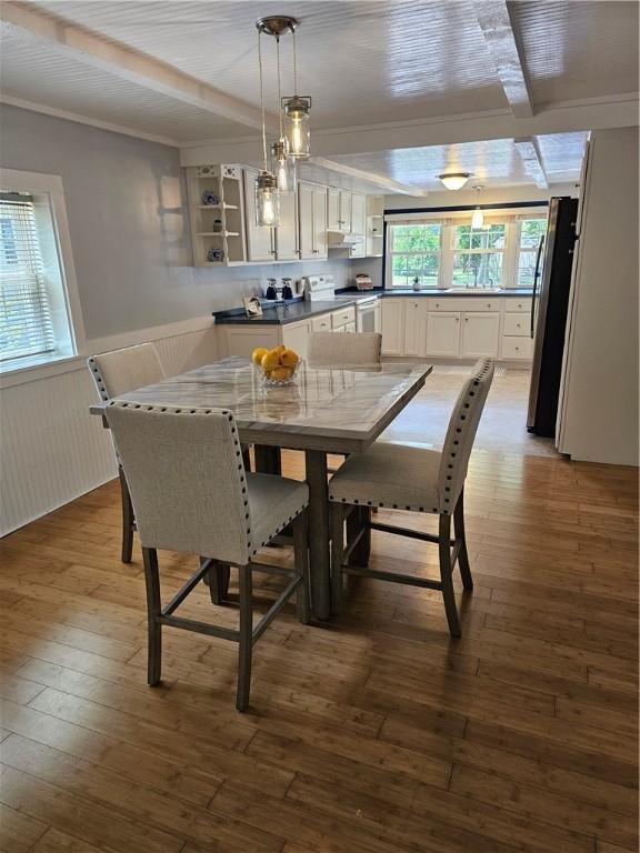 41 Park Ln, Coventry, RI 02816 - dining space with a wainscoted wall, wood-type flooring, and crown molding