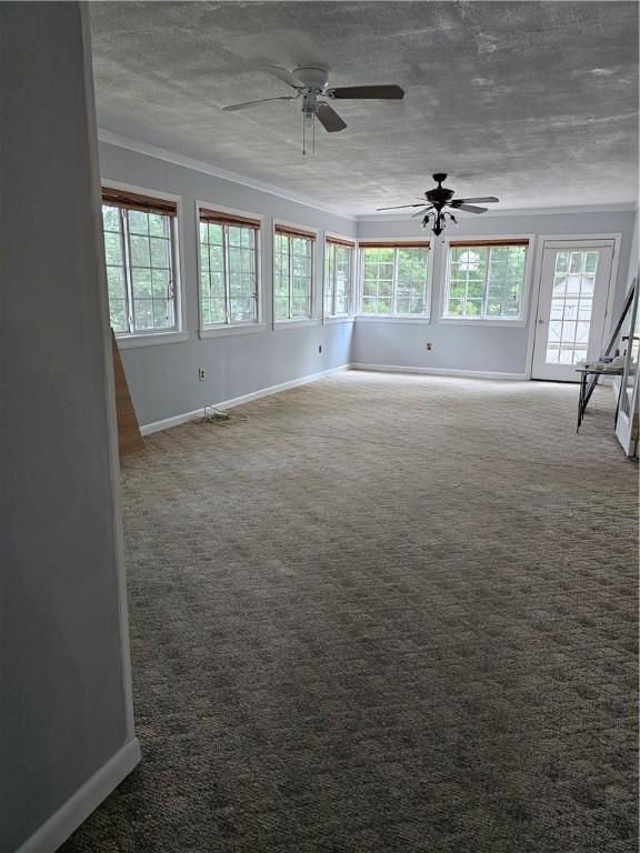 41 Park Ln, Coventry, RI 02816 - empty room featuring ceiling fan, carpet floors, ornamental molding, and a textured ceiling