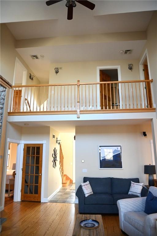 56 Ocean Ridge Dr, Charlestown, RI 02813 - living room with a ceiling fan, a towering ceiling, and wood finished floors