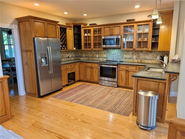 56 Ocean Ridge Dr, Charlestown, RI 02813 - kitchen with stainless steel appliances, brown cabinets, light wood-style floors, and recessed lighting