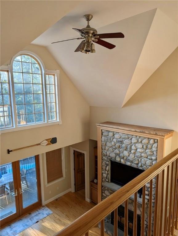 56 Ocean Ridge Dr, Charlestown, RI 02813 - staircase featuring lofted ceiling, wood finished floors, a fireplace, and ceiling fan