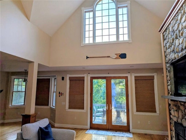 56 Ocean Ridge Dr, Charlestown, RI 02813 - entryway with a fireplace, french doors, plenty of natural light, and high vaulted ceiling