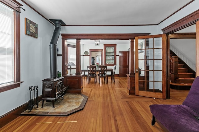 32 Thurston Ave Unit A, Newport, RI 02840 - living area with a wood stove, crown molding, and stairs