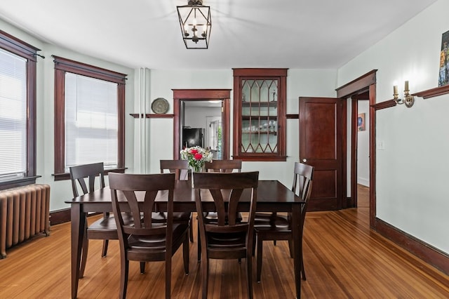 32 Thurston Ave Unit A, Newport, RI 02840 - dining room featuring radiator, light wood-style flooring, and a chandelier