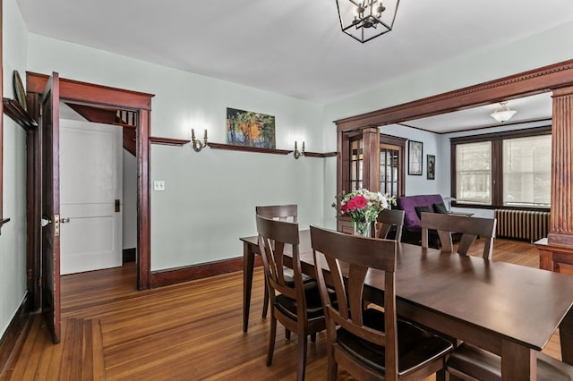 32 Thurston Ave Unit A, Newport, RI 02840 - dining area featuring radiator, wood finished floors, and a chandelier