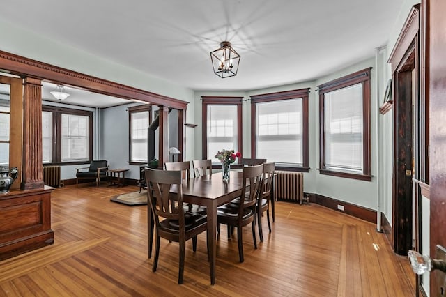32 Thurston Ave Unit A, Newport, RI 02840 - dining room featuring radiator, light wood-style floors, and a chandelier