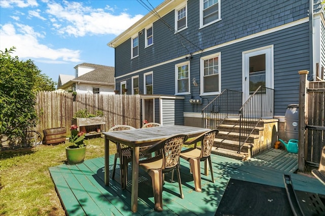 32 Thurston Ave Unit A, Newport, RI 02840 - rear view of house with a wooden deck and outdoor dining area
