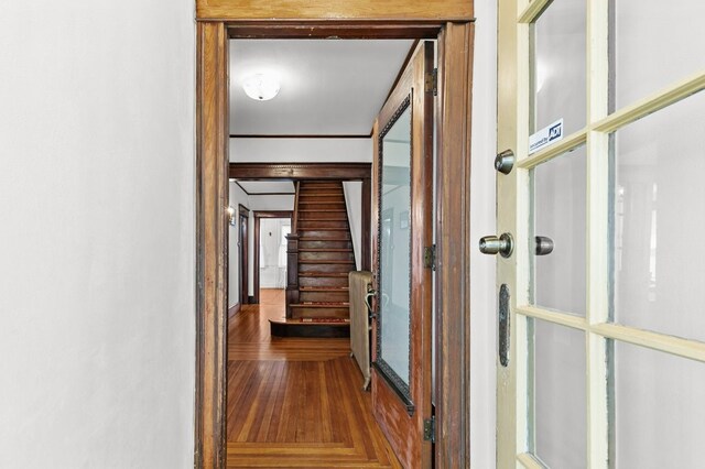 32 Thurston Ave Unit A, Newport, RI 02840 - hall with radiator heating unit, wood finished floors, and stairs