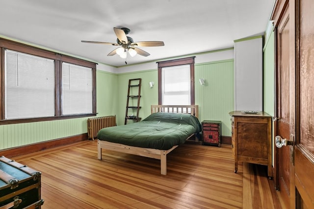 32 Thurston Ave Unit A, Newport, RI 02840 - bedroom with radiator heating unit, light wood-style floors, and a ceiling fan