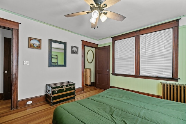 32 Thurston Ave Unit A, Newport, RI 02840 - bedroom featuring radiator heating unit, wood finished floors, and ceiling fan