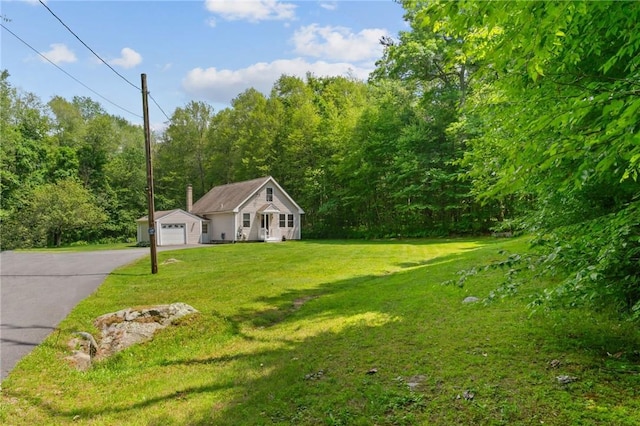 8 Anthony Rd, Foster, RI 02825 - view of front of house with a front lawn, asphalt driveway, and a forest view
