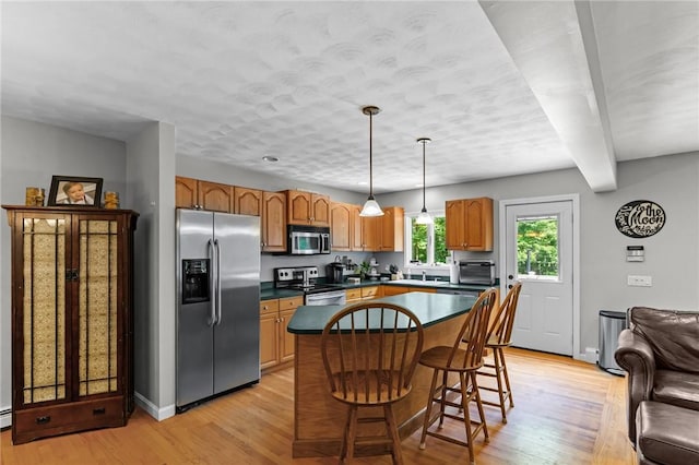 8 Anthony Rd, Foster, RI 02825 - kitchen featuring stainless steel appliances, light wood finished floors, a kitchen island, hanging light fixtures, and beam ceiling