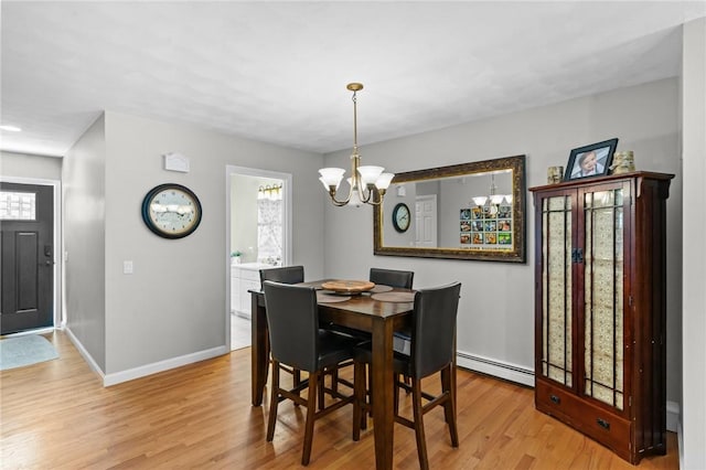 8 Anthony Rd, Foster, RI 02825 - dining area featuring a baseboard heating unit, a chandelier, and light wood-style floors