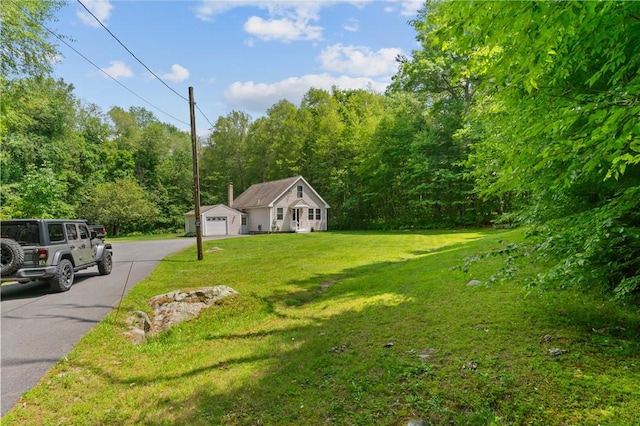 8 Anthony Rd, Foster, RI 02825 - view of front facade with a front yard, a forest view, and a garage