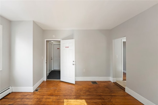 65 Lancaster St Unit 1, Providence, RI 02906 - unfurnished room featuring a baseboard radiator and wood-type flooring